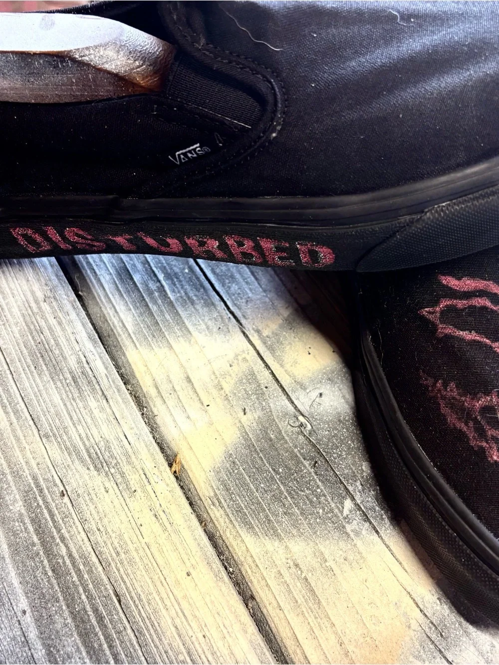 Vans black slip-on canvas sneakers with red hand-painted smiley face